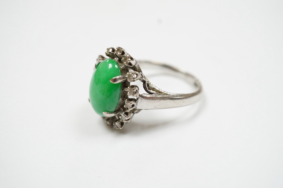 A white metal, jade and diamond set oval cluster ring, size N, gross weight 5.4 grams. Condition - fair to good